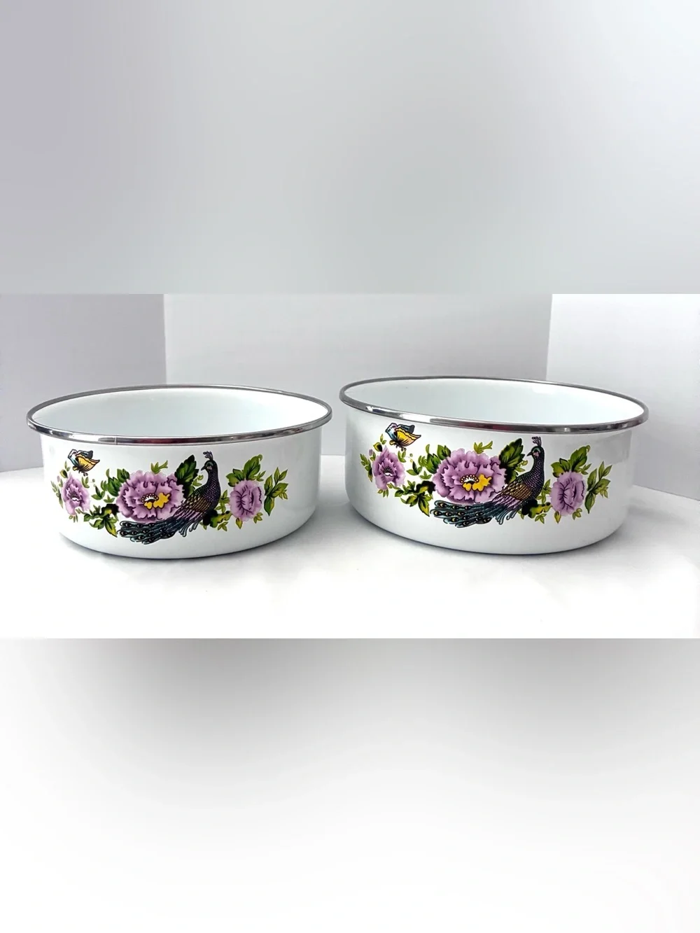 Vintage enamel mixing bowls featuring peacock and floral pattern